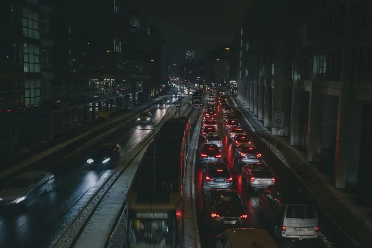 a city street filled with lots of traffic at night